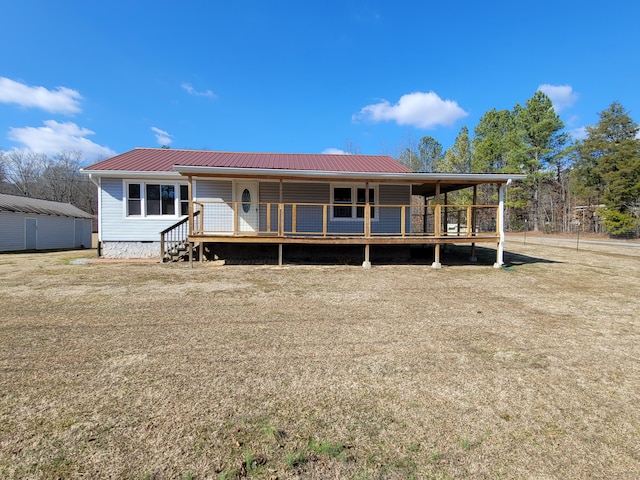 back of house featuring a wooden deck and a yard