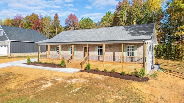 view of front of home with cooling unit and a porch