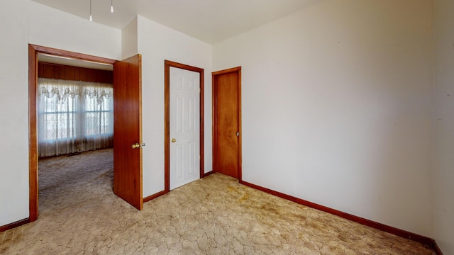 unfurnished bedroom featuring light colored carpet