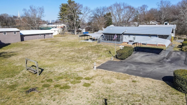 view of yard with a carport and a shed