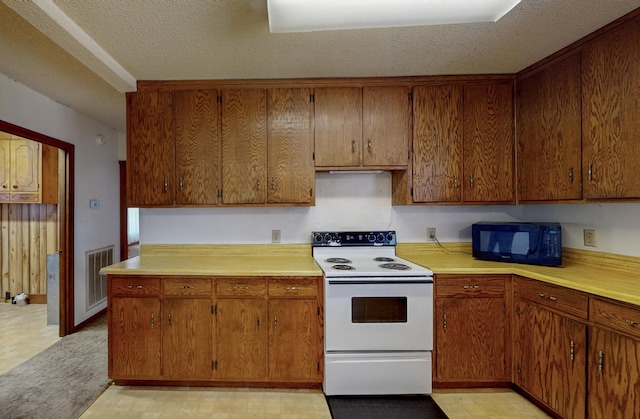 kitchen with electric range and a textured ceiling