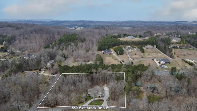 birds eye view of property with a view of trees