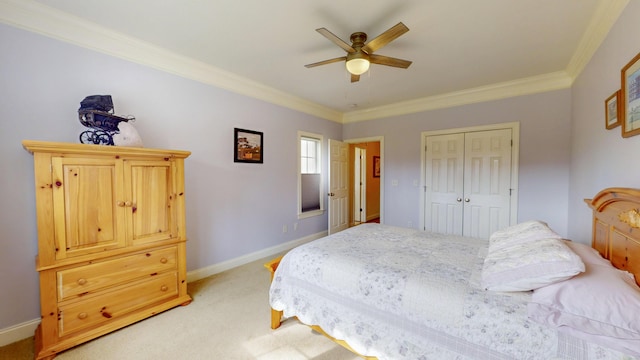 bedroom featuring crown molding, baseboards, a closet, and light carpet