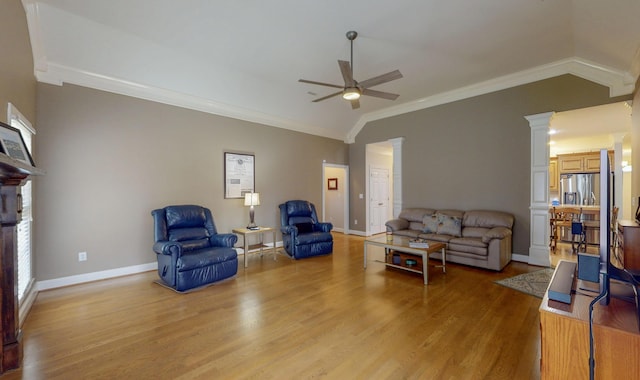 living area featuring lofted ceiling, light wood-style flooring, decorative columns, and a ceiling fan