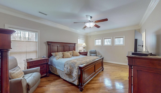 bedroom featuring crown molding, baseboards, visible vents, and light wood-type flooring