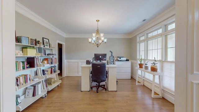 office space with washer / dryer, an inviting chandelier, ornamental molding, and light wood finished floors