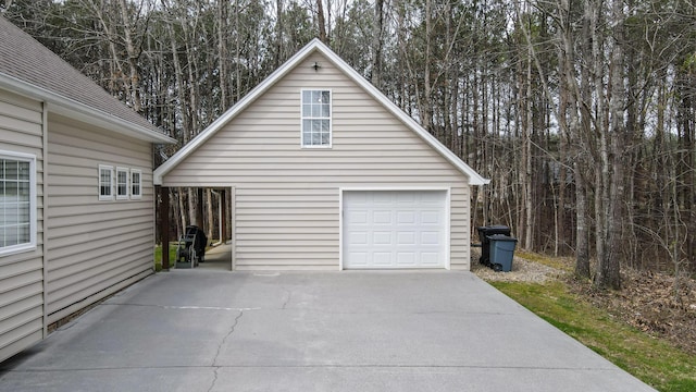 detached garage with concrete driveway