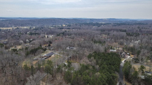 birds eye view of property featuring a wooded view