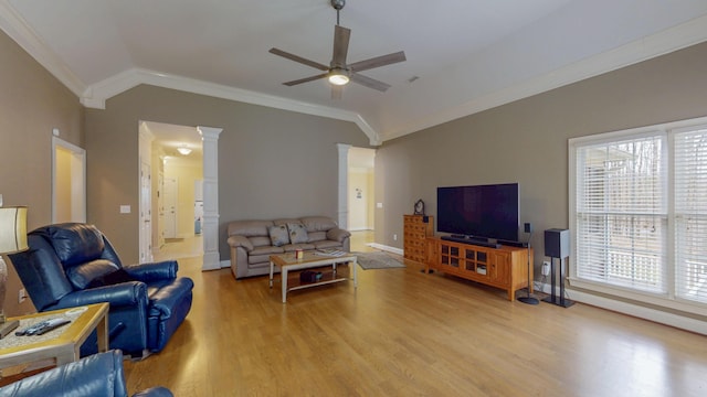 living area featuring a ceiling fan, lofted ceiling, decorative columns, light wood-type flooring, and a wealth of natural light