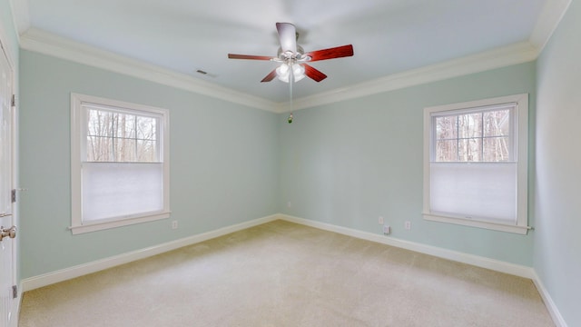 unfurnished room with visible vents, light colored carpet, ornamental molding, and a ceiling fan