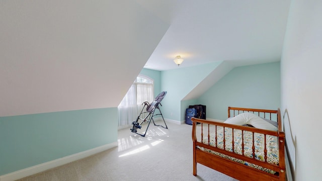 bedroom featuring vaulted ceiling, carpet flooring, and baseboards