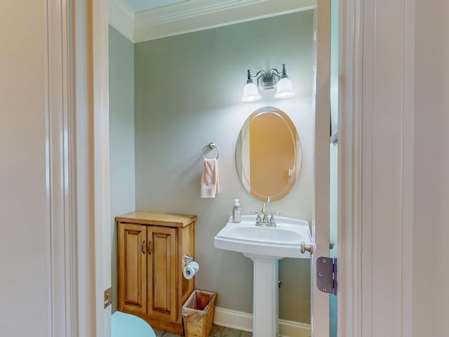 bathroom featuring toilet, baseboards, and ornamental molding