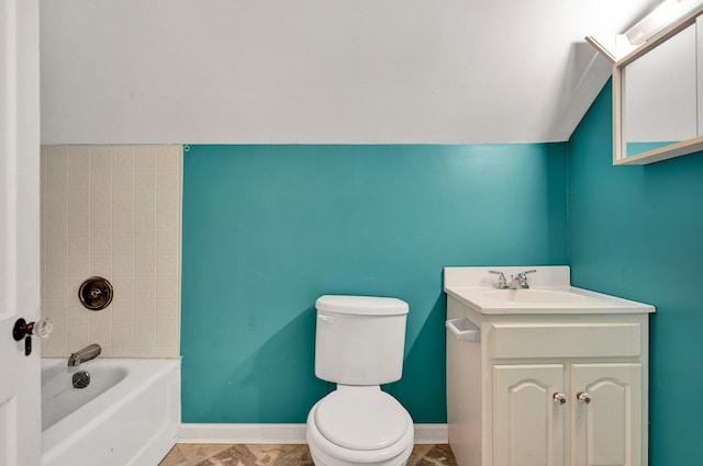 bathroom featuring vanity, vaulted ceiling, a bathing tub, and toilet