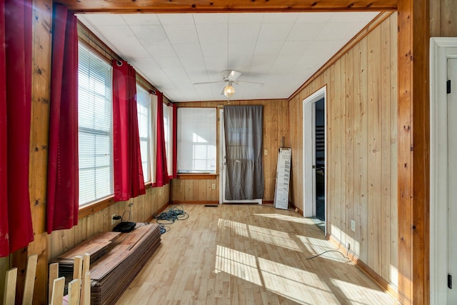 unfurnished sunroom with ceiling fan