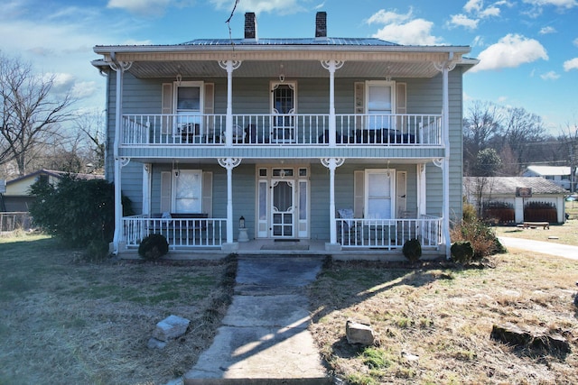 front of property with a balcony and covered porch