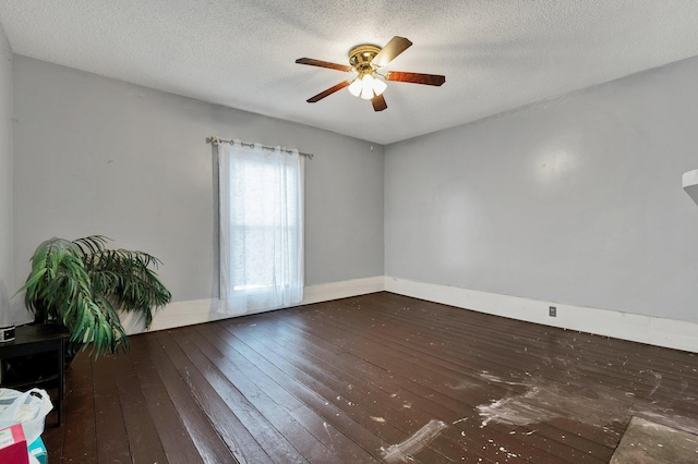 spare room with dark wood-type flooring, a textured ceiling, and ceiling fan