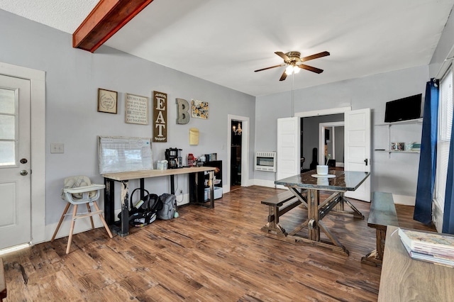 dining area with ceiling fan, wood-type flooring, heating unit, and beamed ceiling