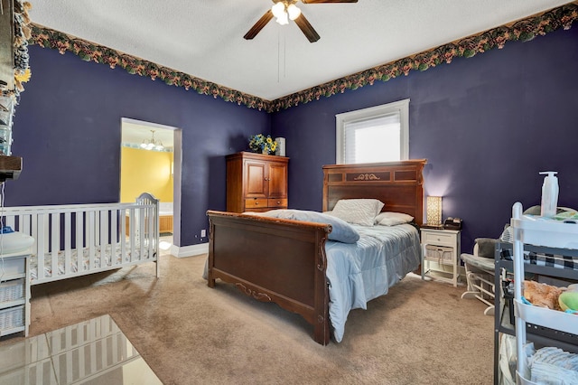 bedroom with ceiling fan, a textured ceiling, and light carpet