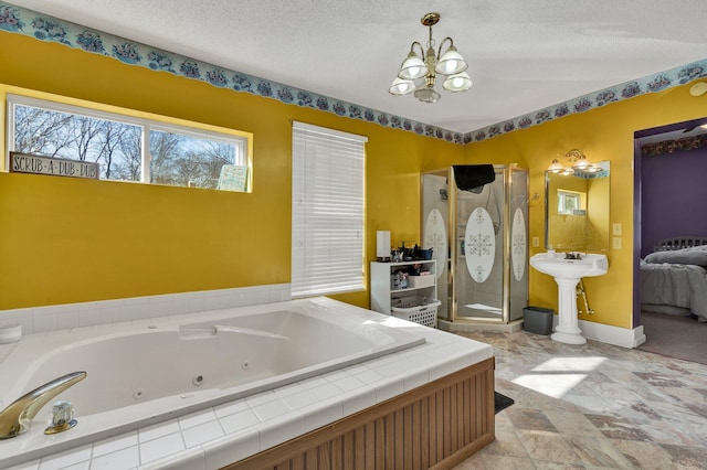 bathroom featuring sink, a chandelier, a textured ceiling, and tiled tub