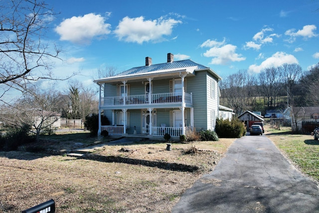 view of front of property with a balcony and covered porch