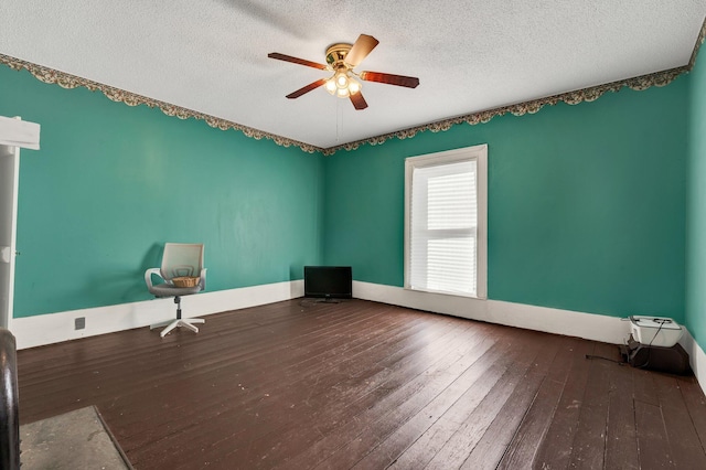 spare room with ceiling fan, a textured ceiling, and wood-type flooring