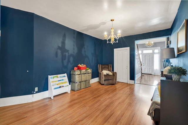 interior space featuring wood-type flooring and a chandelier