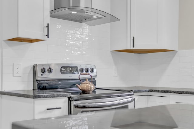 1050 King Edward Ave SE, Cleveland, TN 37311 - kitchen featuring island range hood, stainless steel electric stove, backsplash, white cabinets, and dark stone counters