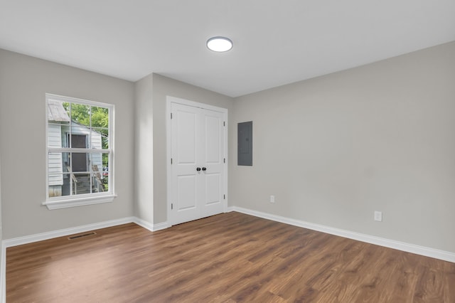 1050 King Edward Ave SE, Cleveland, TN 37311 - empty room with wood finished floors and electric panel