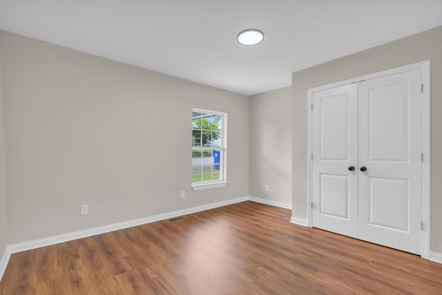 1050 King Edward Ave SE, Cleveland, TN 37311 - unfurnished bedroom featuring wood finished floors and a closet