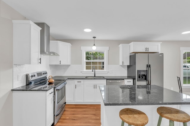 1050 King Edward Ave SE, Cleveland, TN 37311 - kitchen featuring appliances with stainless steel finishes, wall chimney exhaust hood, white cabinets, a kitchen breakfast bar, and recessed lighting