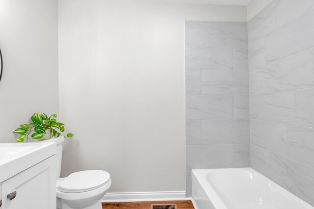 1050 King Edward Ave SE, Cleveland, TN 37311 - bathroom with a tub, vanity, and wood finished floors