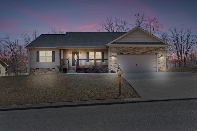 ranch-style home with covered porch and a garage