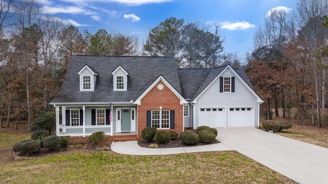 view of front of house with a garage, covered porch, and a front lawn