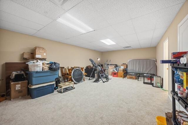 interior space featuring carpet and a drop ceiling