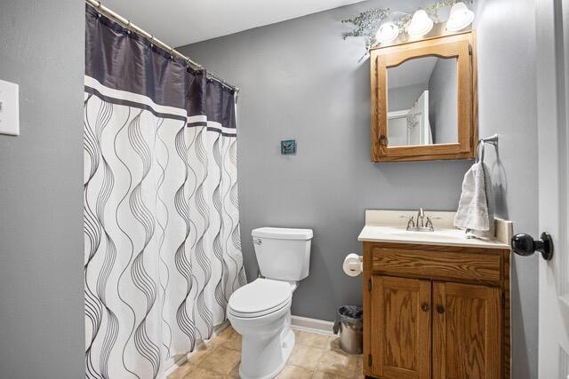 bathroom with tile patterned flooring, vanity, and toilet