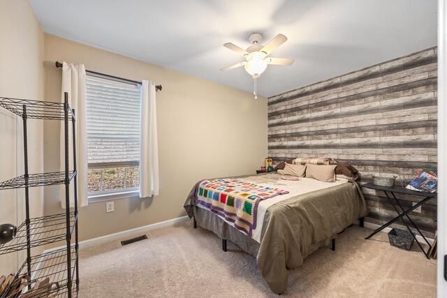 carpeted bedroom with ceiling fan