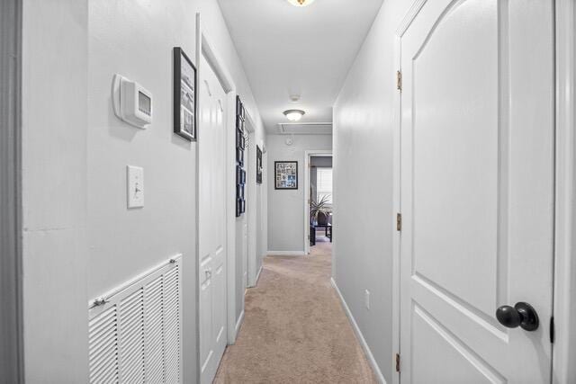 hall featuring light colored carpet