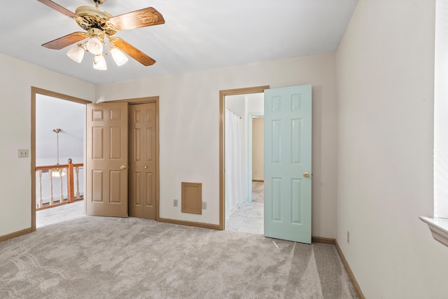 unfurnished bedroom featuring ceiling fan, a closet, and light carpet