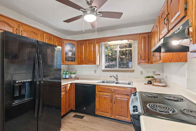 kitchen with ceiling fan, sink, a textured ceiling, black appliances, and light wood-type flooring