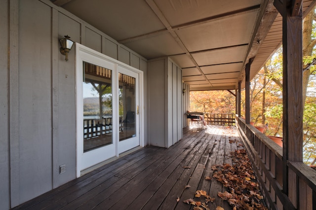 wooden terrace featuring covered porch