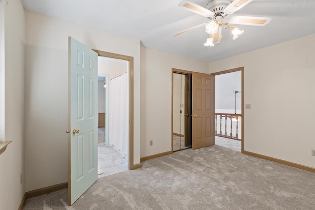 unfurnished bedroom featuring light carpet, a closet, and ceiling fan