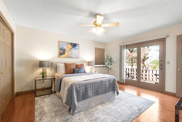 bedroom featuring access to outside, ceiling fan, a closet, and hardwood / wood-style flooring