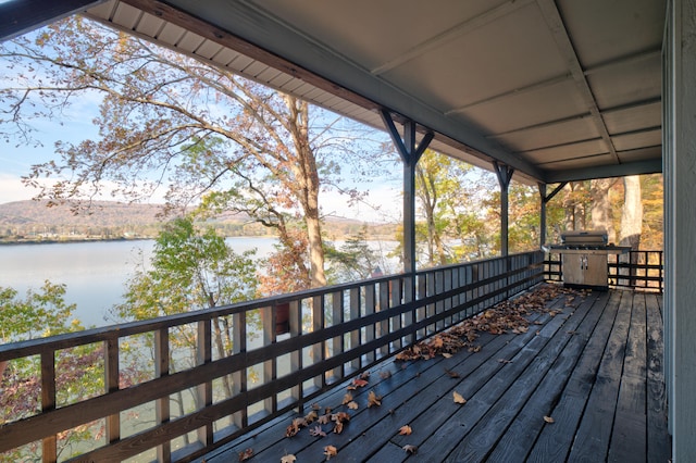 wooden deck featuring a water view