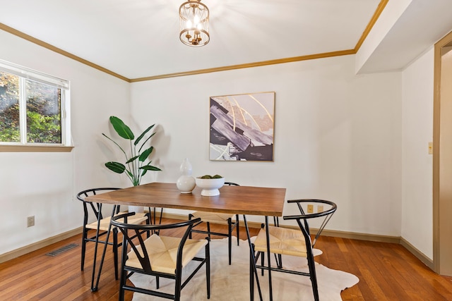 dining area featuring light hardwood / wood-style flooring and ornamental molding