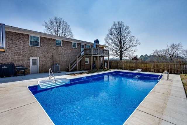 view of swimming pool with a patio, stairway, central AC unit, fence, and a grill