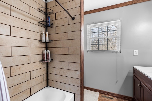 full bath with vanity,  shower combination, baseboards, and visible vents