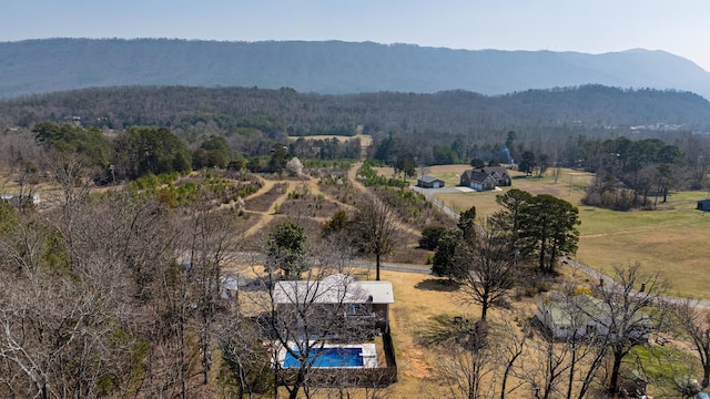 drone / aerial view featuring a mountain view, a rural view, and a wooded view