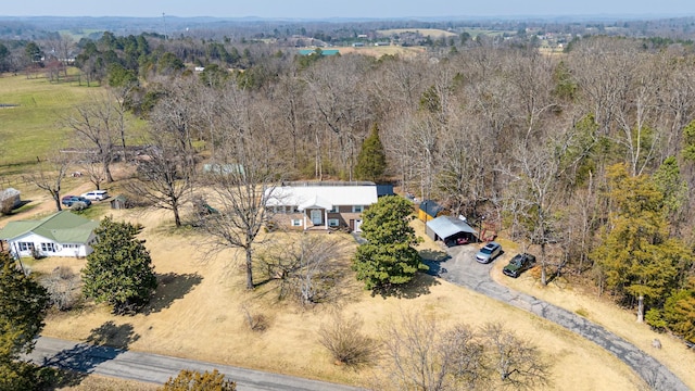 birds eye view of property featuring a view of trees