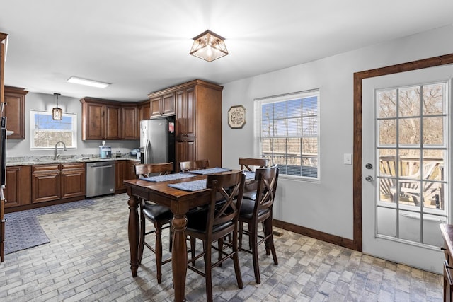 dining room with brick floor and baseboards