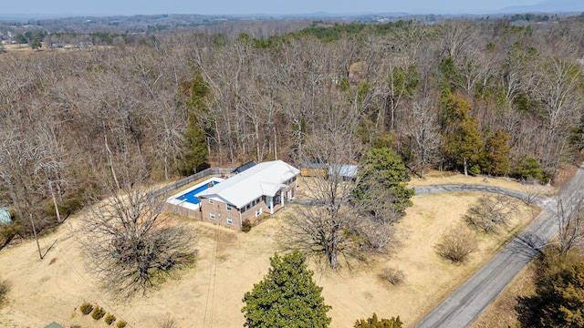 aerial view featuring a wooded view